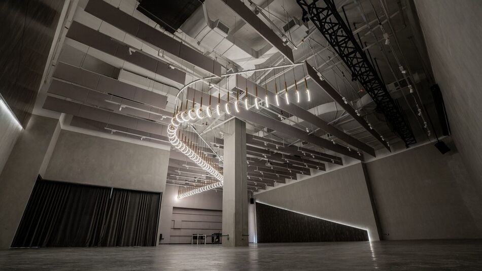Steel trusses and the filament spiral across the Grey Box ceiling